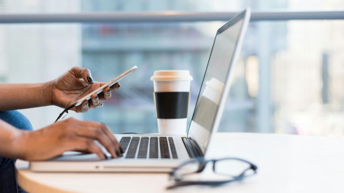 Woman with telephone and laptop