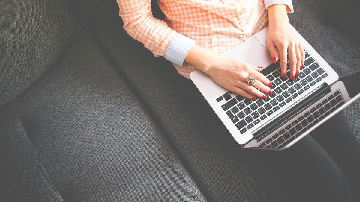 Woman writing laptop