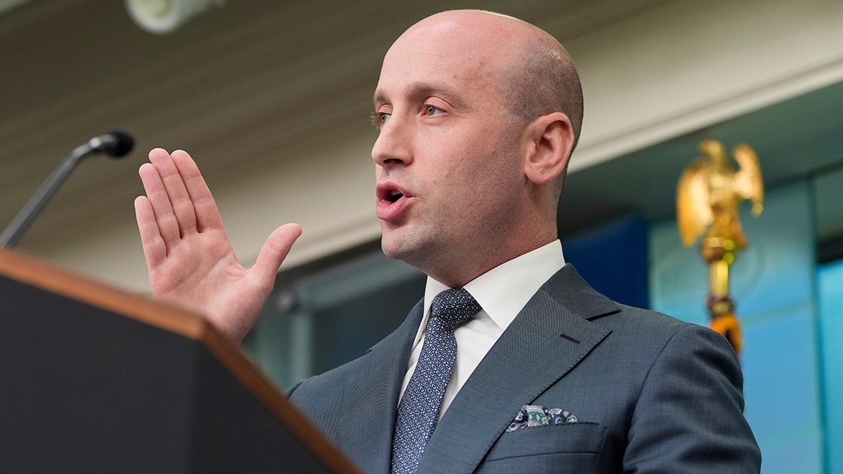 Stephen Miller doing a gesture on the podium