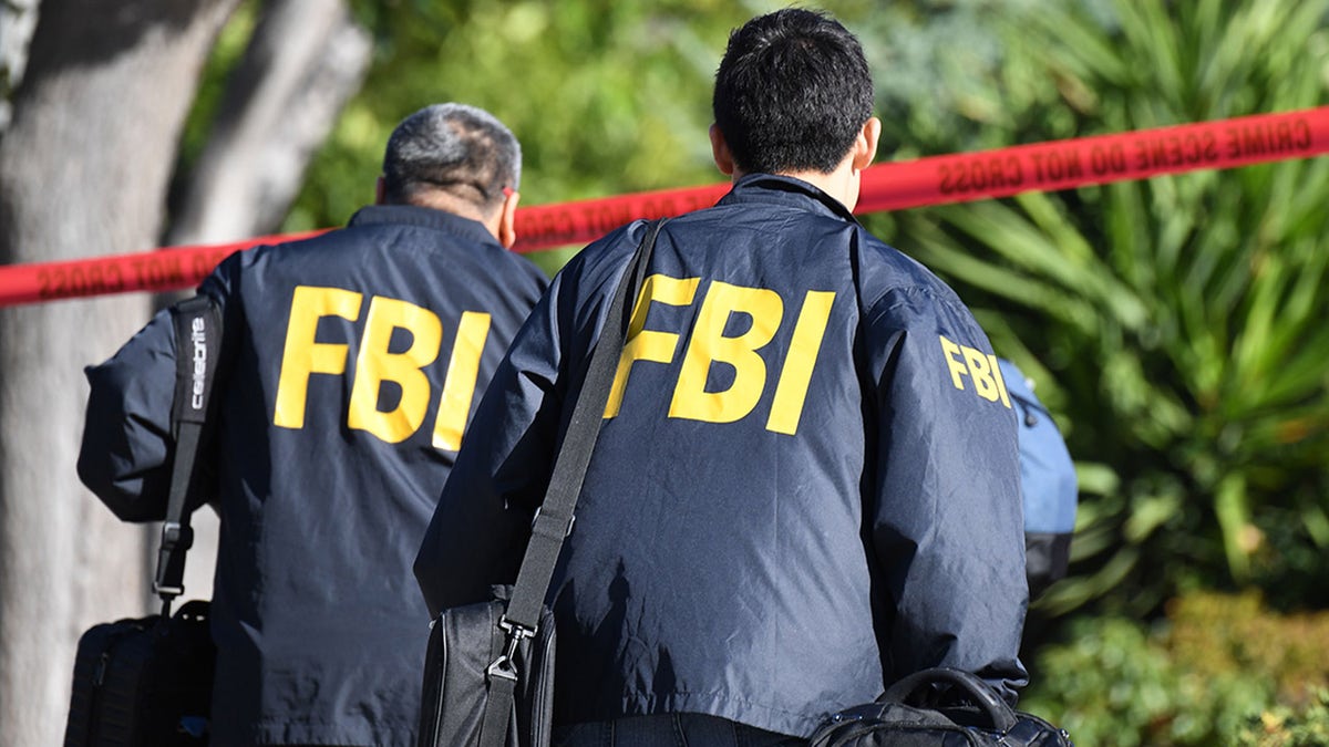 Agents of the Federal Investigation Office walking around the crime site